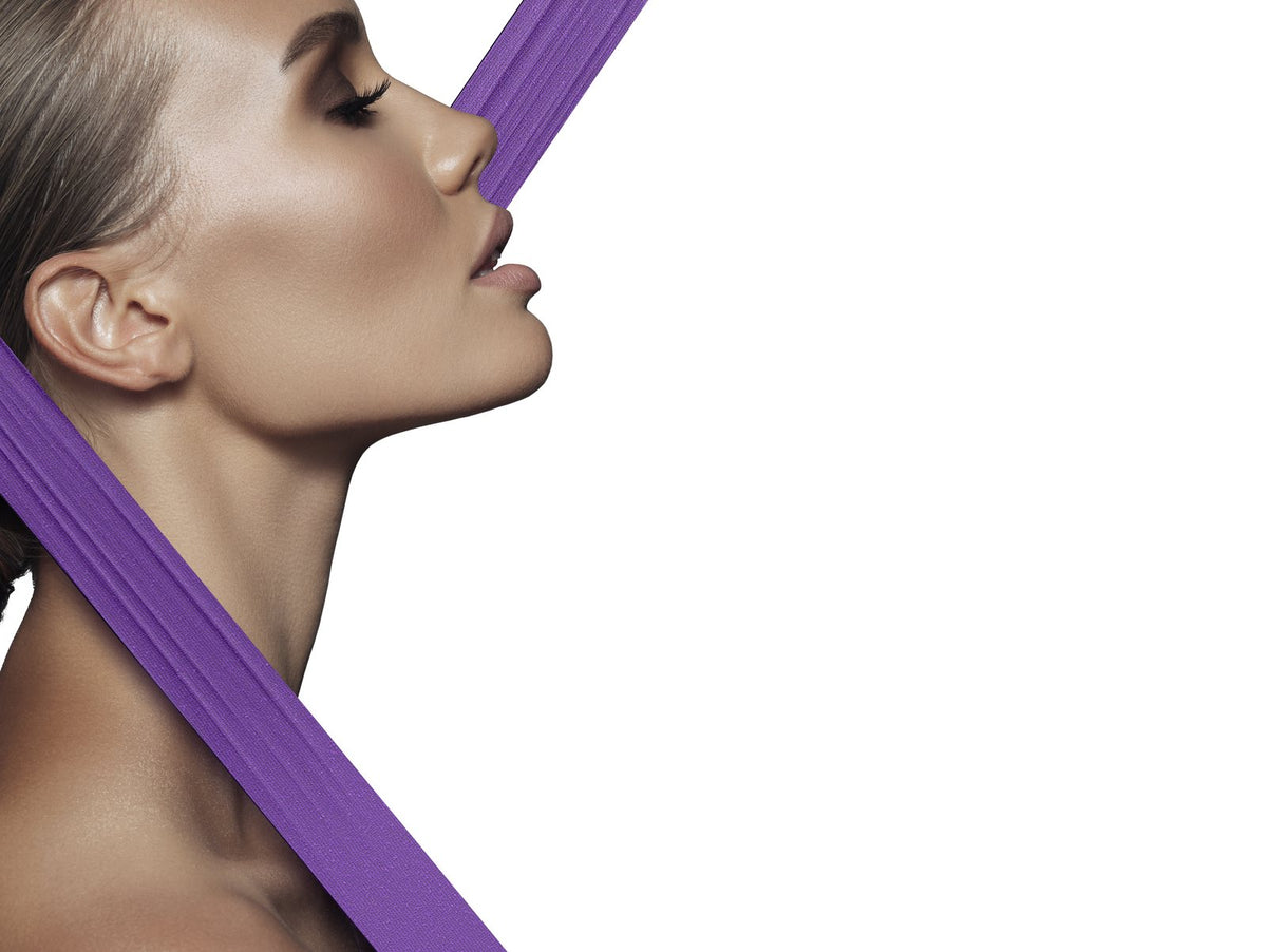 The V-Shape campaign — violet ribbons tracing the V of the jaw and neck