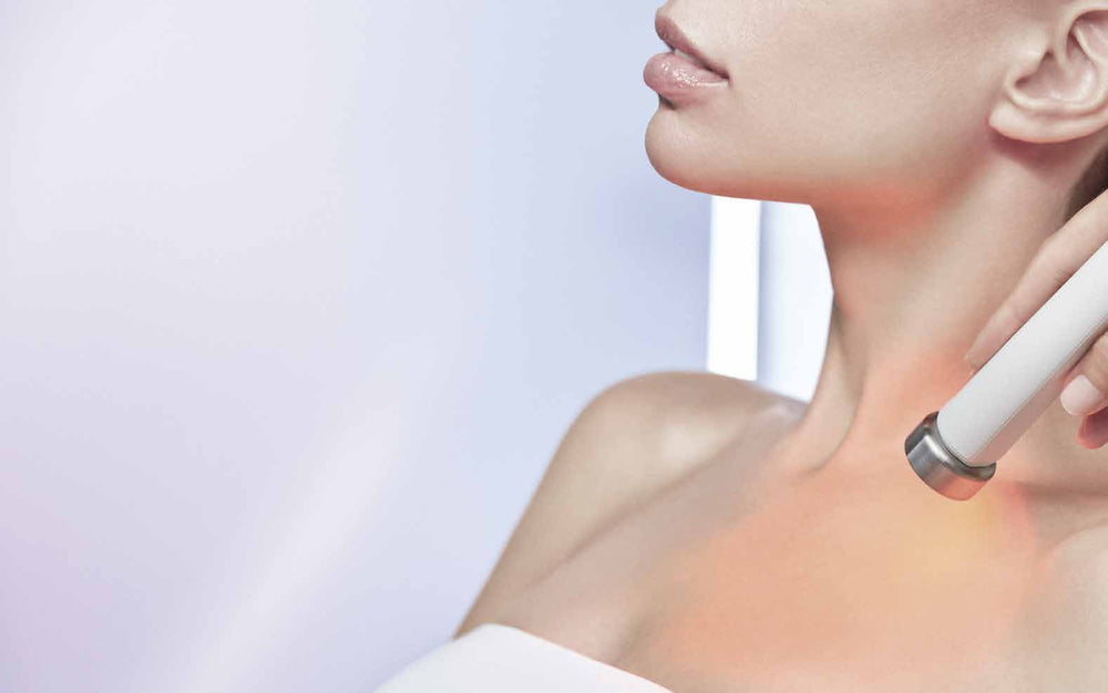 The Dermaboost handpiece glowing against the décolletage